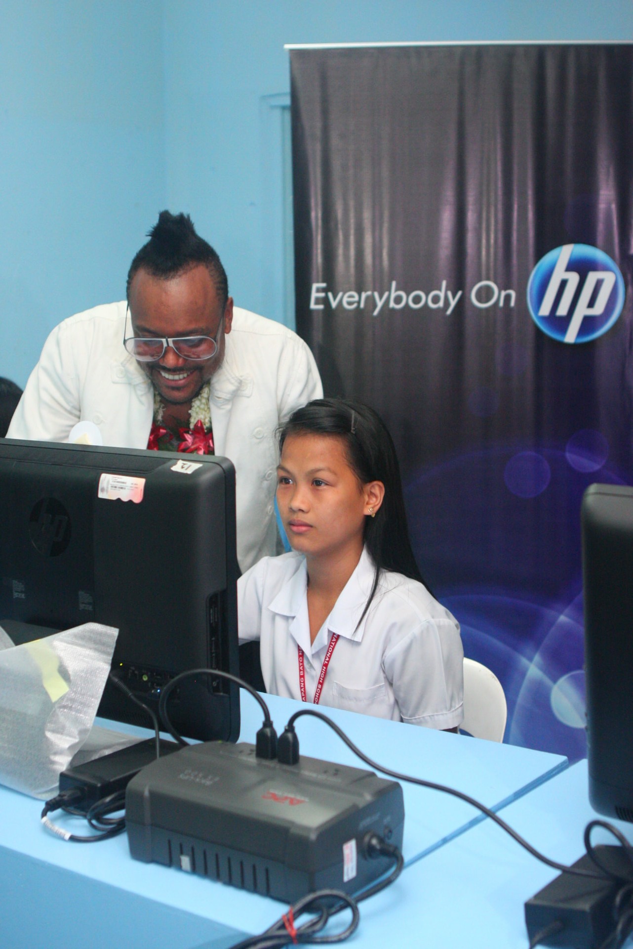 Opening Doors in Sapang Bato and Pampanga - Apl works alongside a student in the donated computer lab